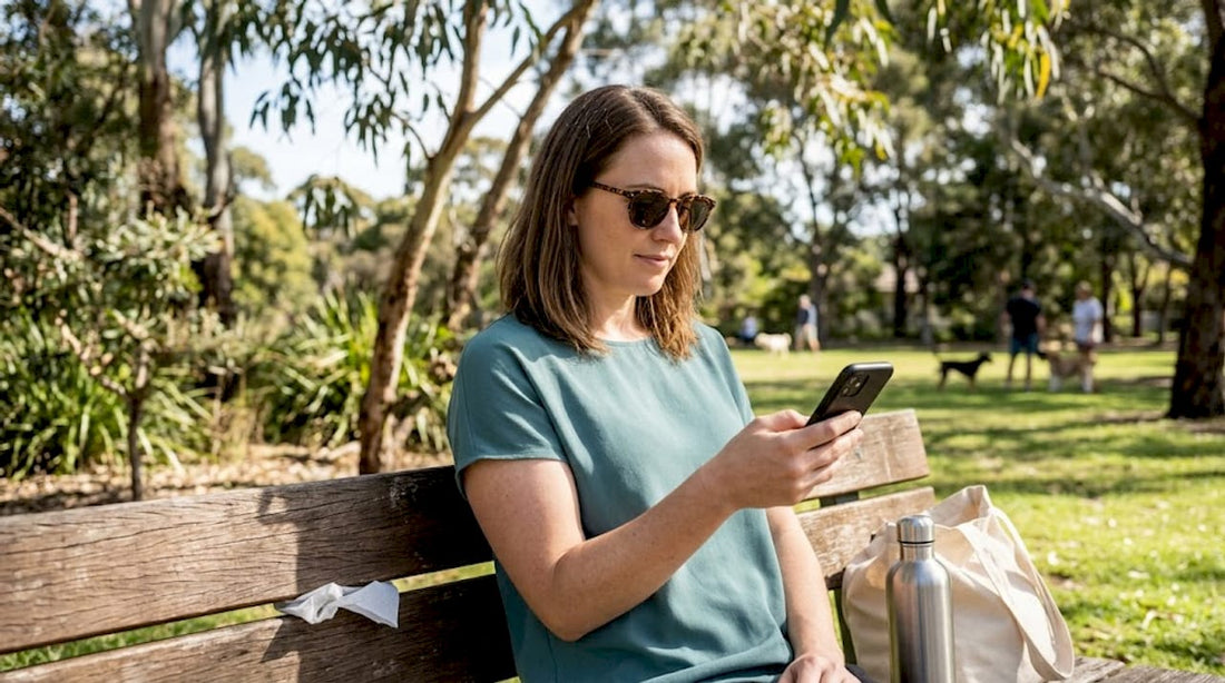 Woman reading on bench in prescription sunglasses