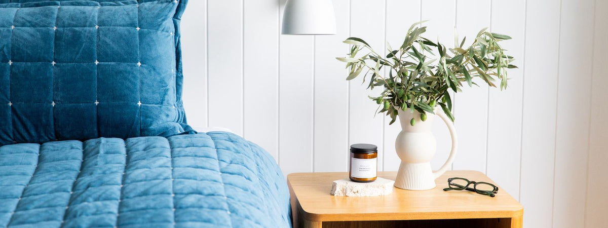 premium reading glasses next to a bed