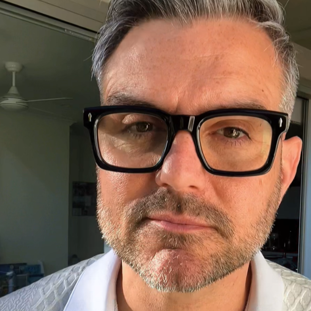 Australian man wearing square black reading glasses