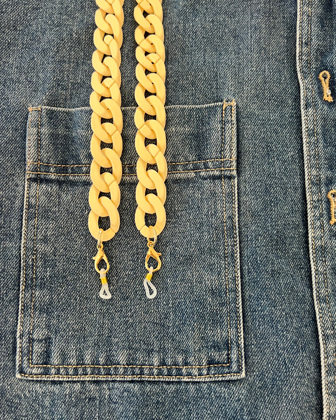 Chunky ivory white acrylic glasses chain, displayed on a denim jacket. Ministry of Sight