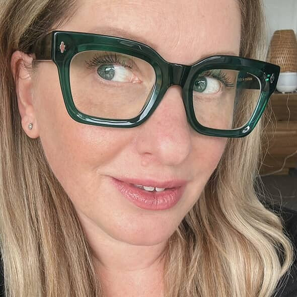 Close-up of Australian woman wearing stylish green reading glasses