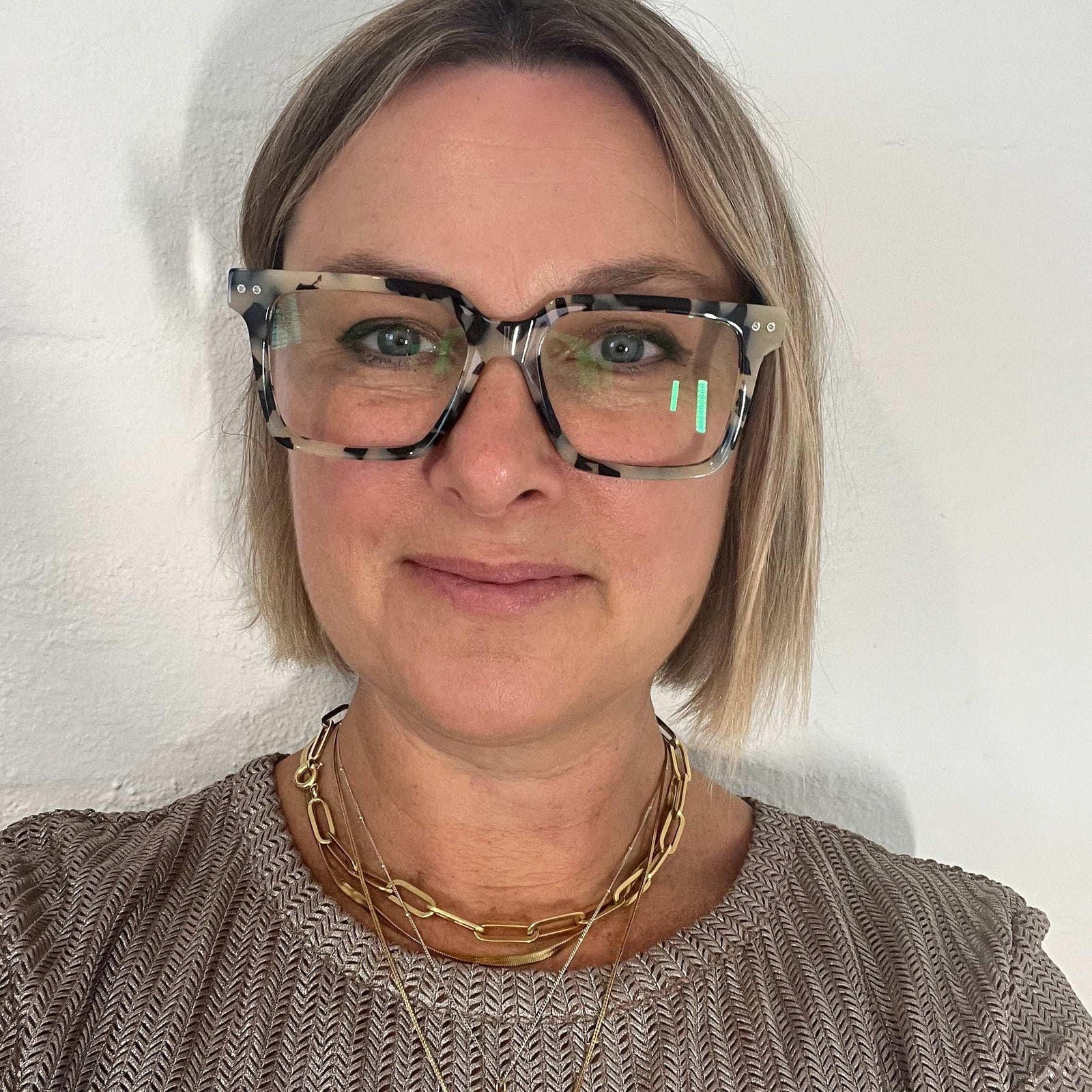 Australian woman wearing stylish white and black leopard reading glasses - Ministry of Sight