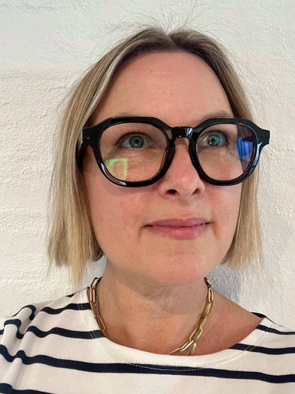 Stylish woman over 40 wearing Modern unisex round black reading glasses with flat top frame – Ministry of Sight