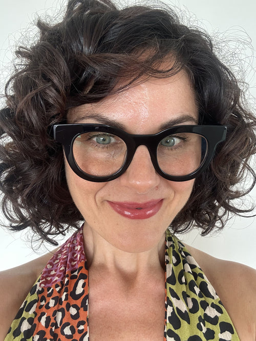 Australian stylish Woman wearing black  round reading glasses with a leopard print top on a white background - Ministry of Sight readers