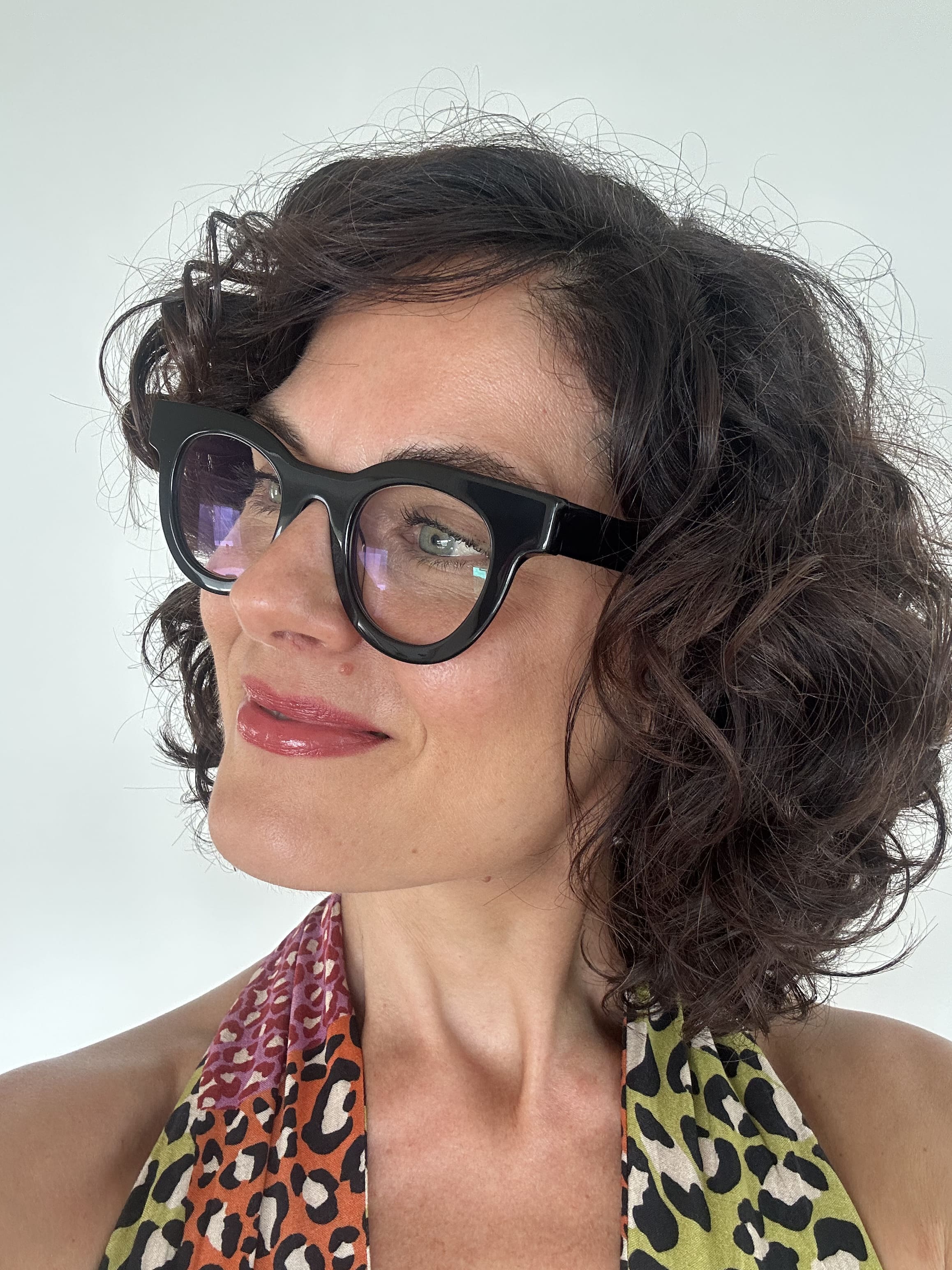 Australian stylish Woman wearing black  round reading glasses with a leopard print top on a white background - Ministry of Sight readers