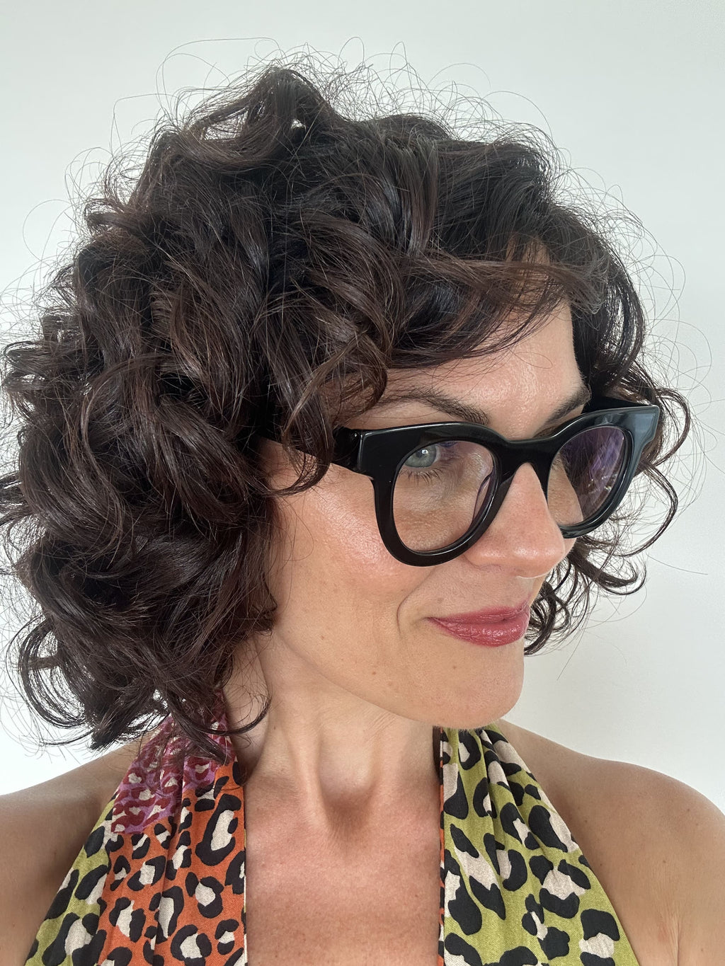 Australian stylish Woman wearing black  round reading glasses with a leopard print top on a white background - Ministry of Sight readers
