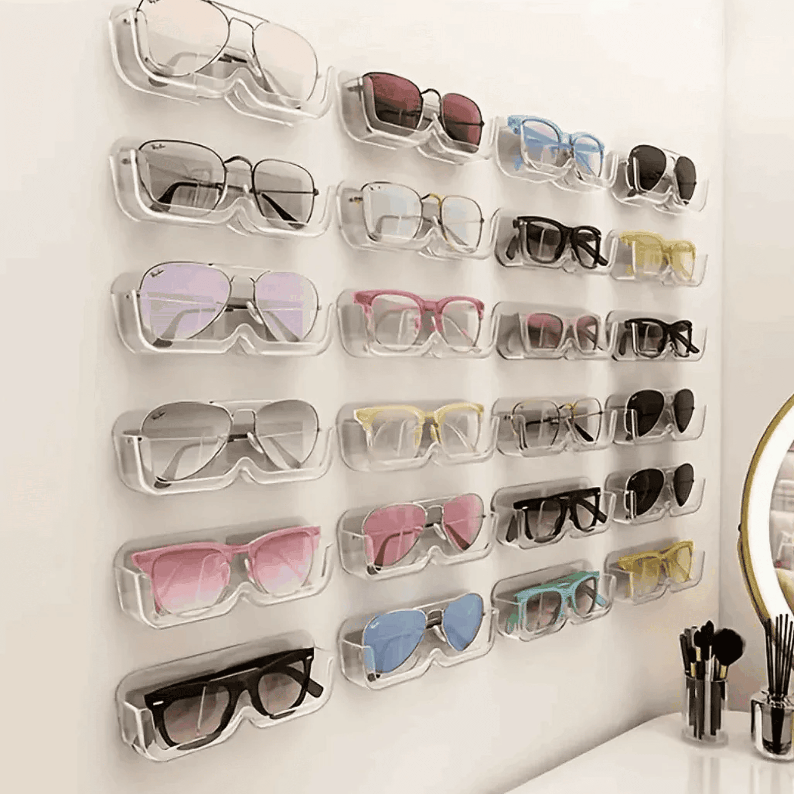 Wall-mounted eyeglasses organiser with various pairs of glasses on a light background - Ministry of Sight Lens Lounge