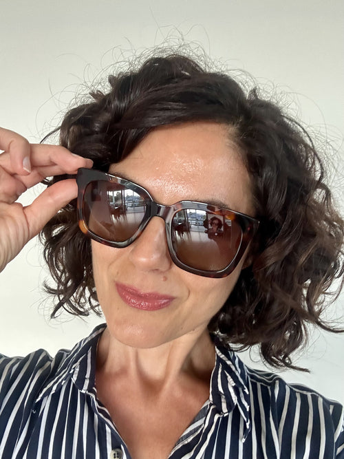 Woman wearing oversized polarised tortoiseshell sun reading glasses