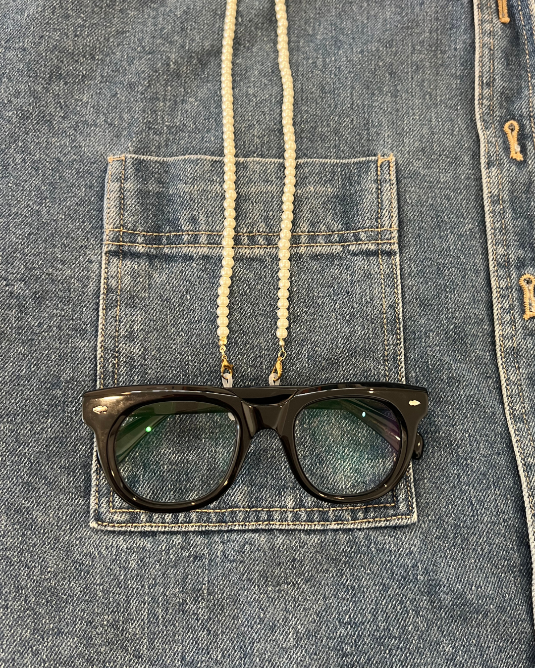 Denim shirt with pearl glasses and sunglasses chain accessory so you don't lose your glasses, Black round stylish reading glasses. Ministry of Sight.