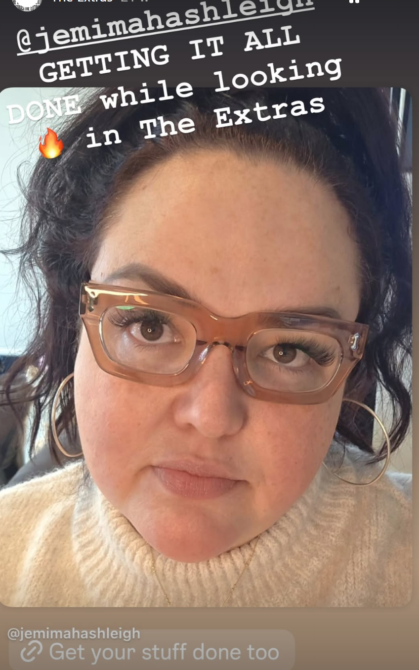 Australian woman wearing pink reading glasses while working hard