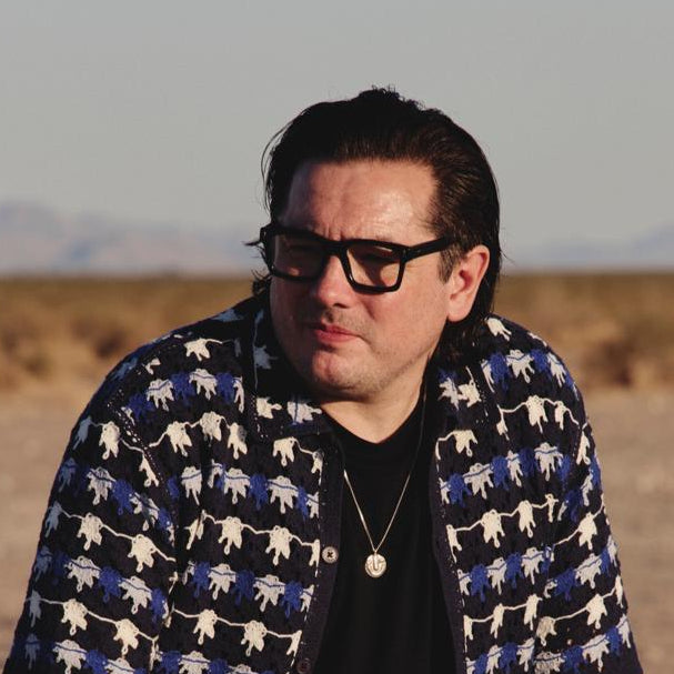 Man in desert wearing square thick frame reading glasses from ministry fo sight