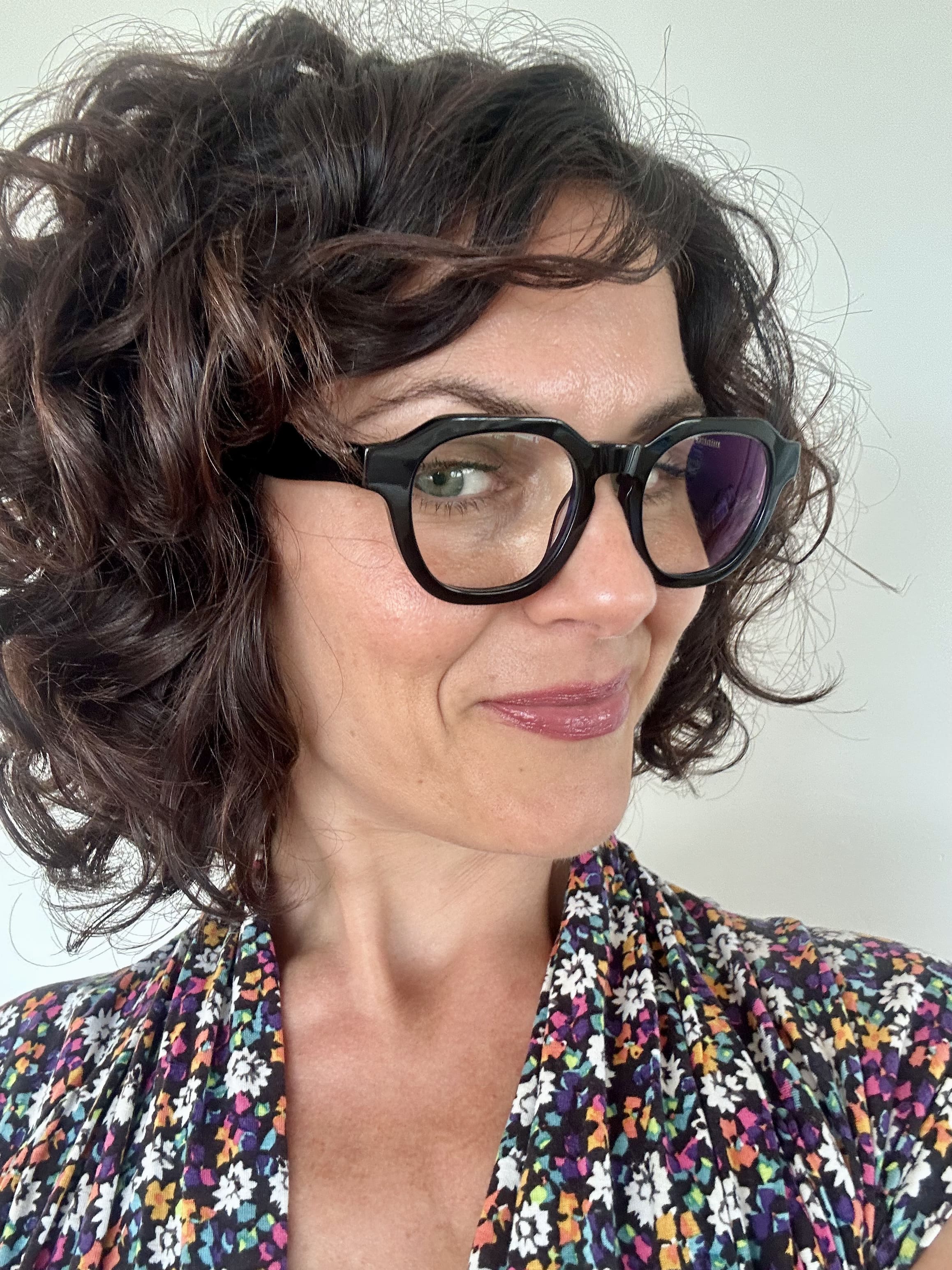 Australian woman in a floral top wearing The Flat Top black reading glasses  - ministry of sight readers