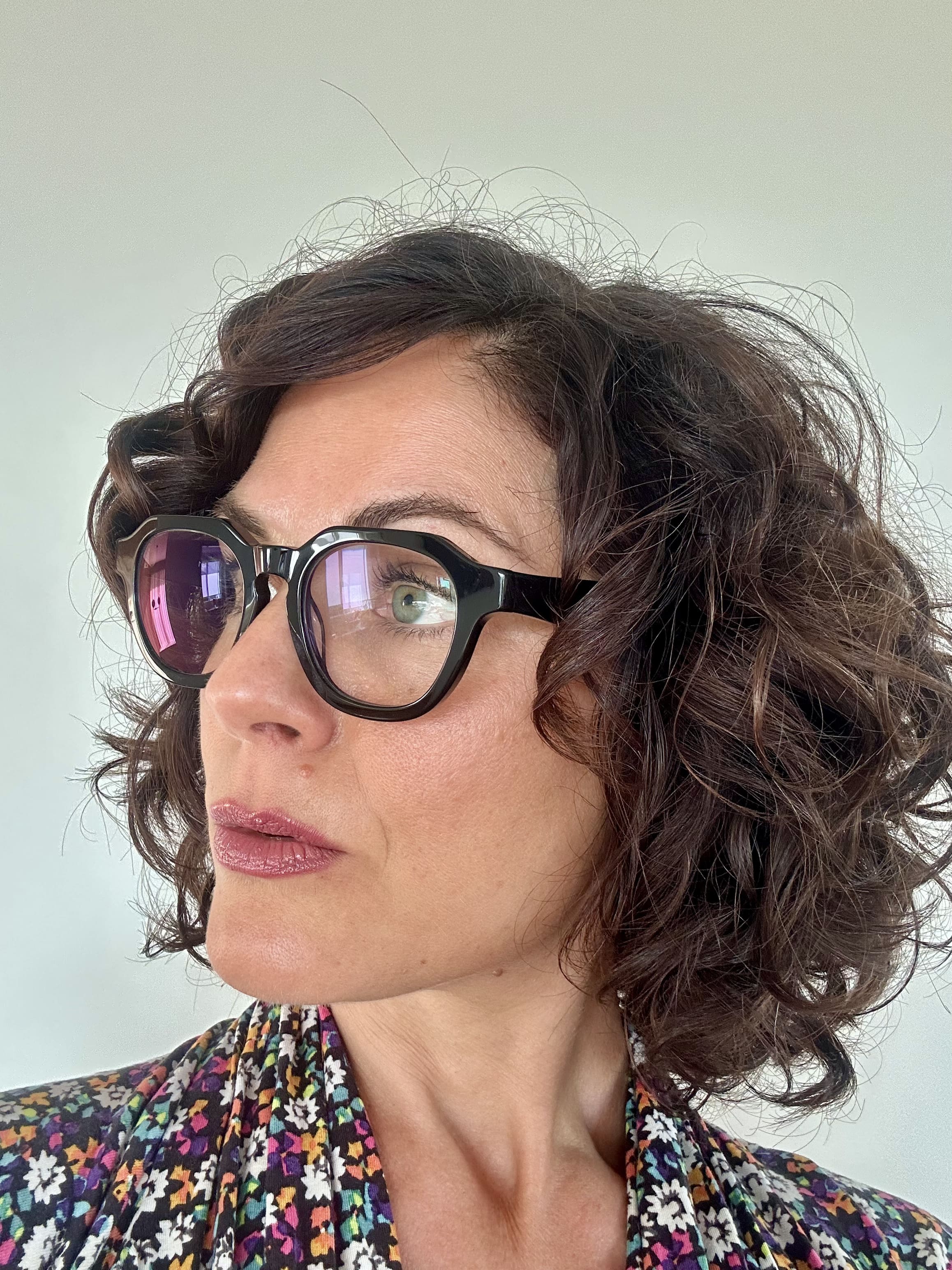 Australian woman in a floral top wearing The Flat Top black reading glasses  - ministry of sight readers