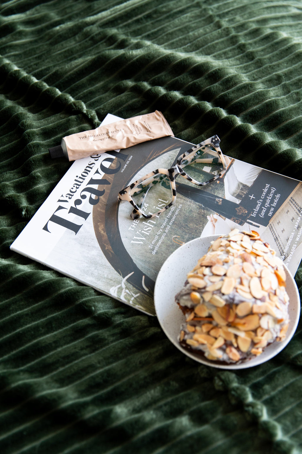 Flat lay of magazine, breakfast and reading glasses