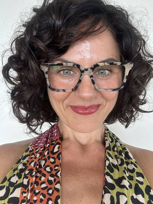 Stylish woman over 40 wearing premium blue light blocking tortoiseshell square reading glasses