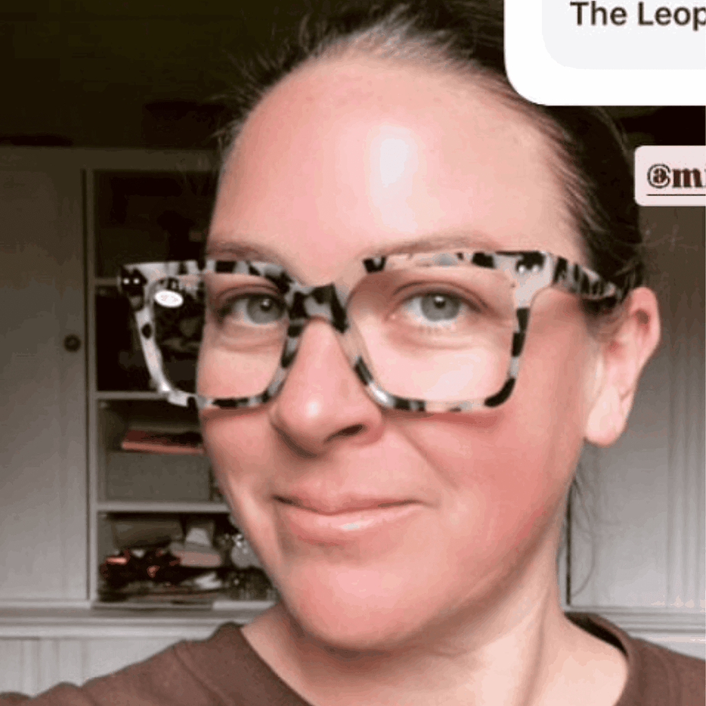 Stylish photographer over 40 wearing premium blue light blocking tortoiseshell square reading glasses 