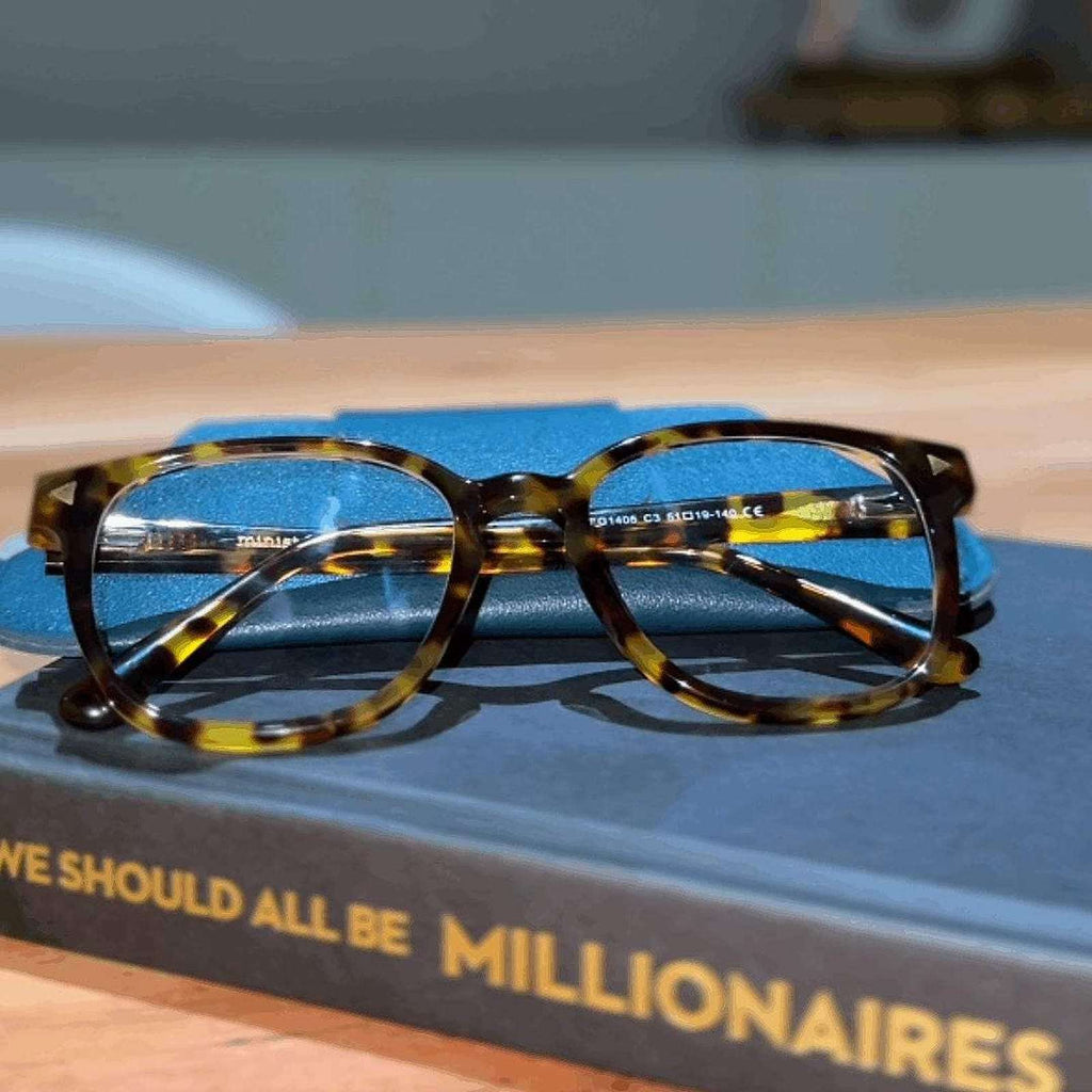 Tortoiseshell reading glasses on a book - Ministry of Sight stylish readers