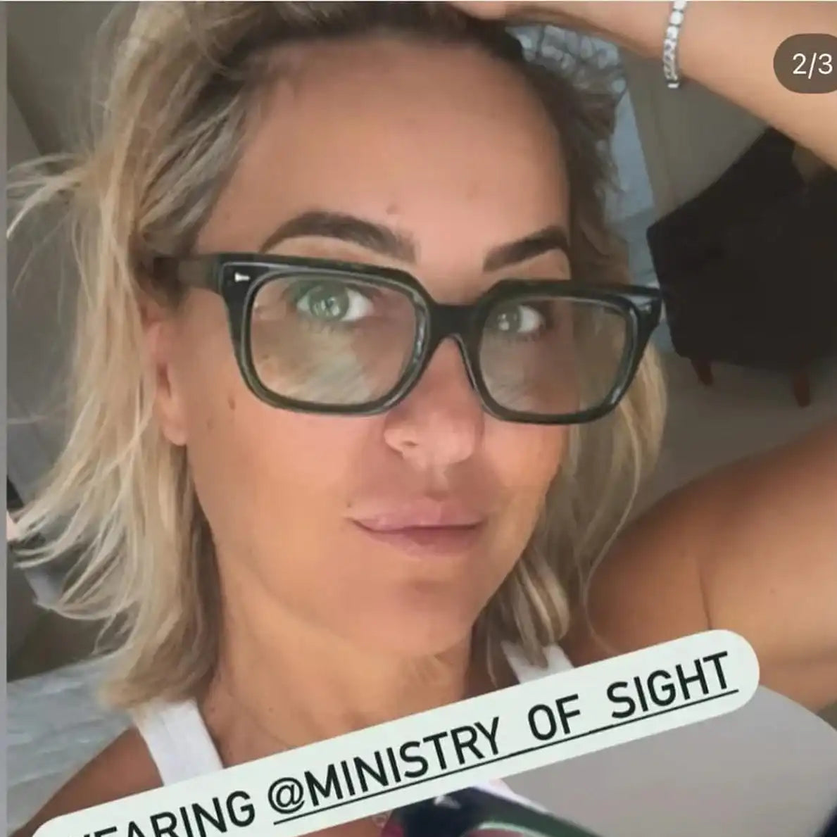 Person wearing reading glasses with text overlay about the brand 'Ministry of Sight'.