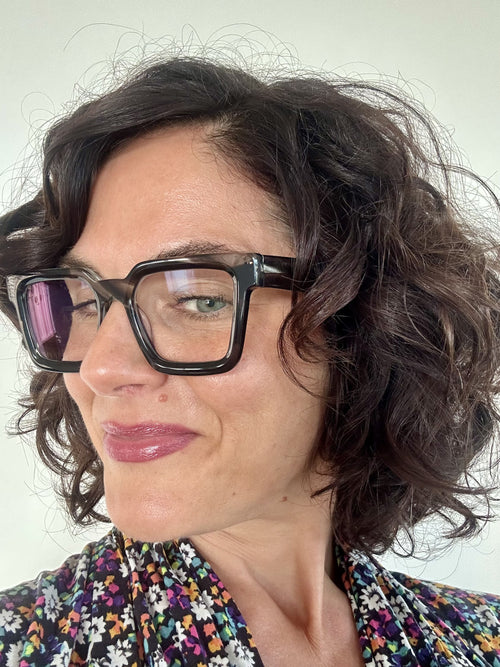 Flattering grey marble square reading glasses on an Australian woman over 40 with brown curly hair - Ministry of Sight readers for men and women