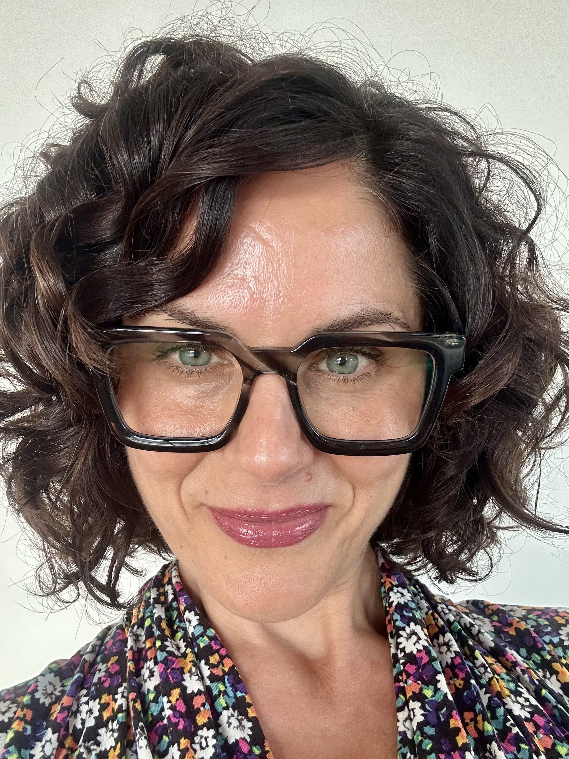 Flattering grey marble square reading glasses on an Australian woman over 40 with brown curly hair - Ministry of Sight readers for men and women