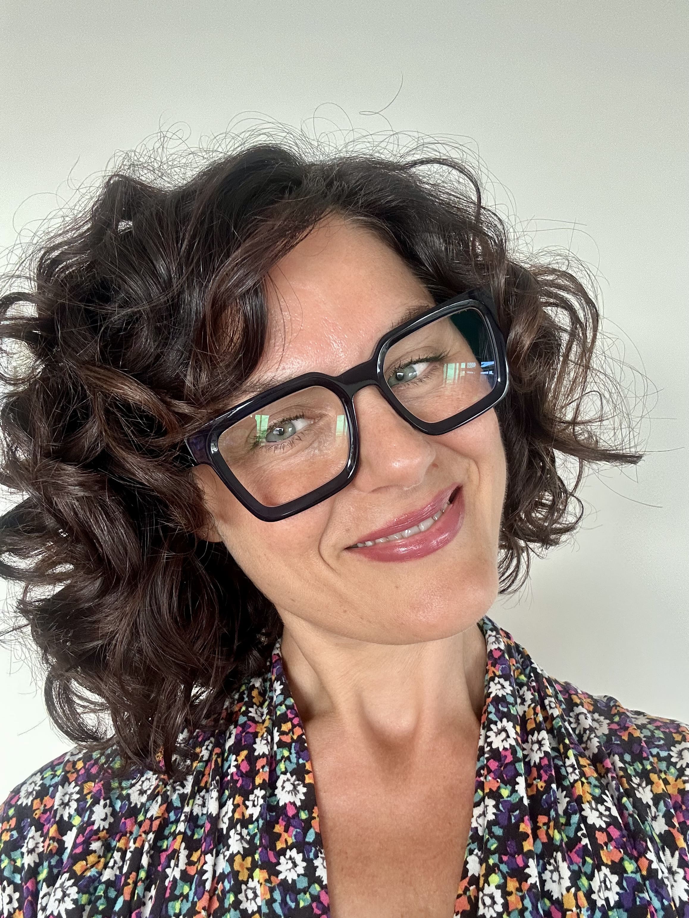Flattering navy square reading glasses on an Australian woman over 40 with brown curly hair - Ministry of Sight readers for men and women
