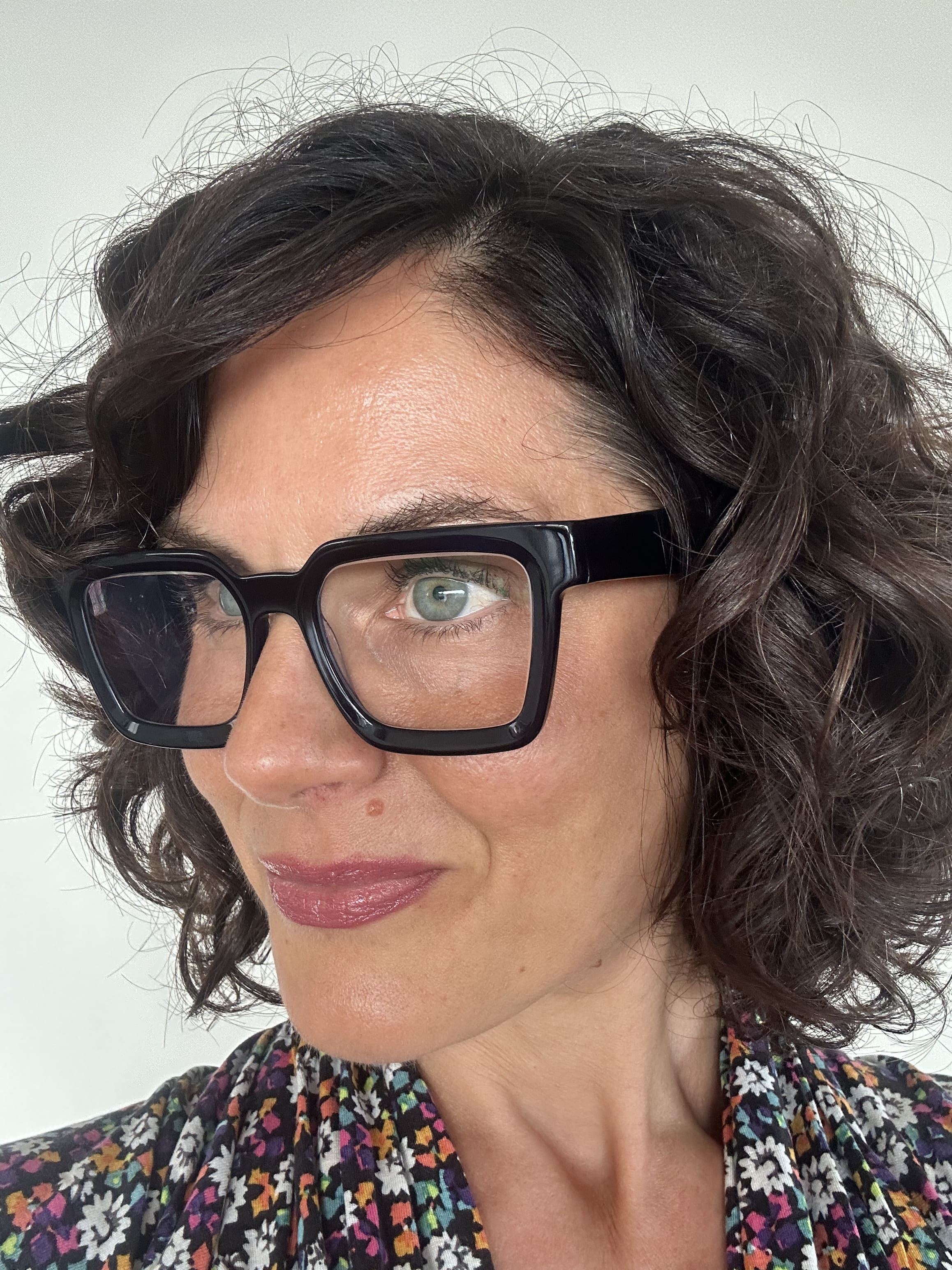 Flattering navy square reading glasses on an Australian woman over 40 with brown curly hair - Ministry of Sight readers for men and women