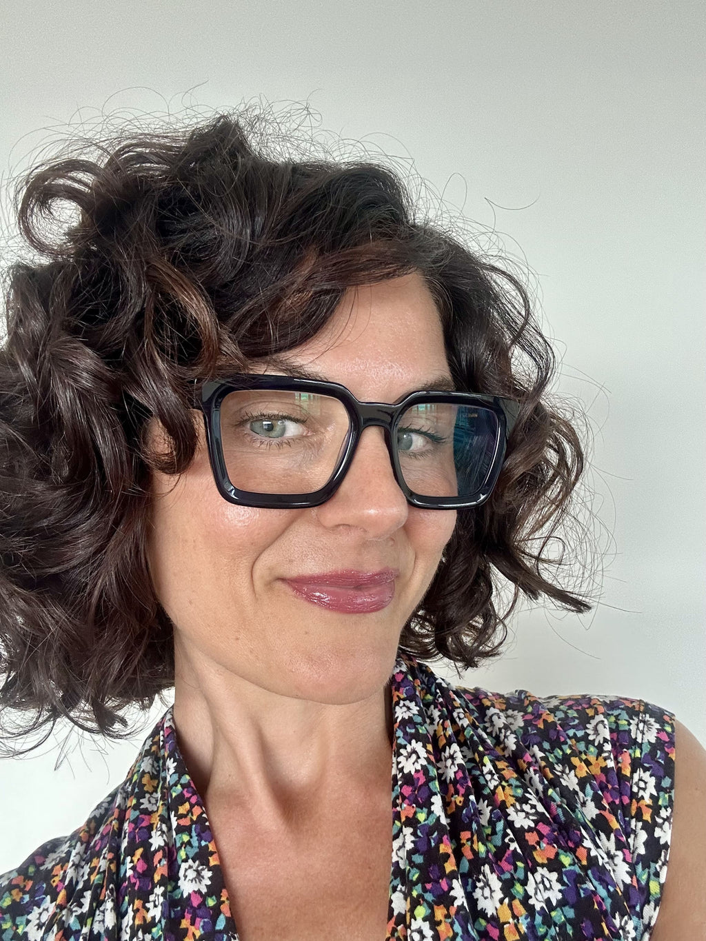 Fashionable navy square reading glasses on an Australian woman over 40 with brown curly hair - Ministry of Sight readers for men and women