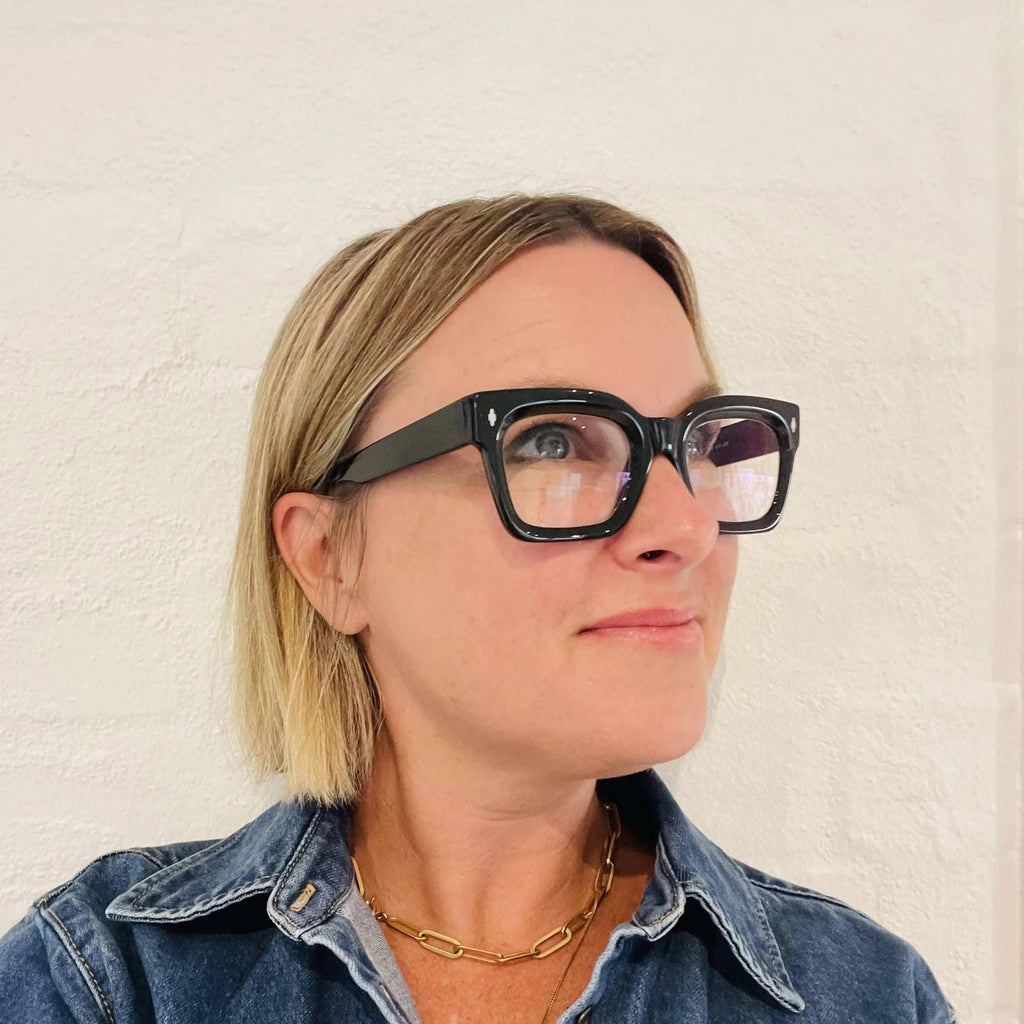 Blonde woman in denim wearing The Standards casual readers in black ministry of sight 
