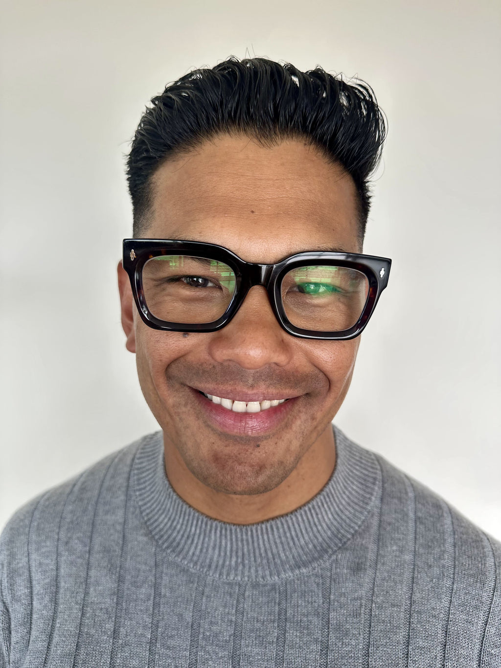 Man wearing premium square black reading glasses with blue light blocking and a gray sweater 