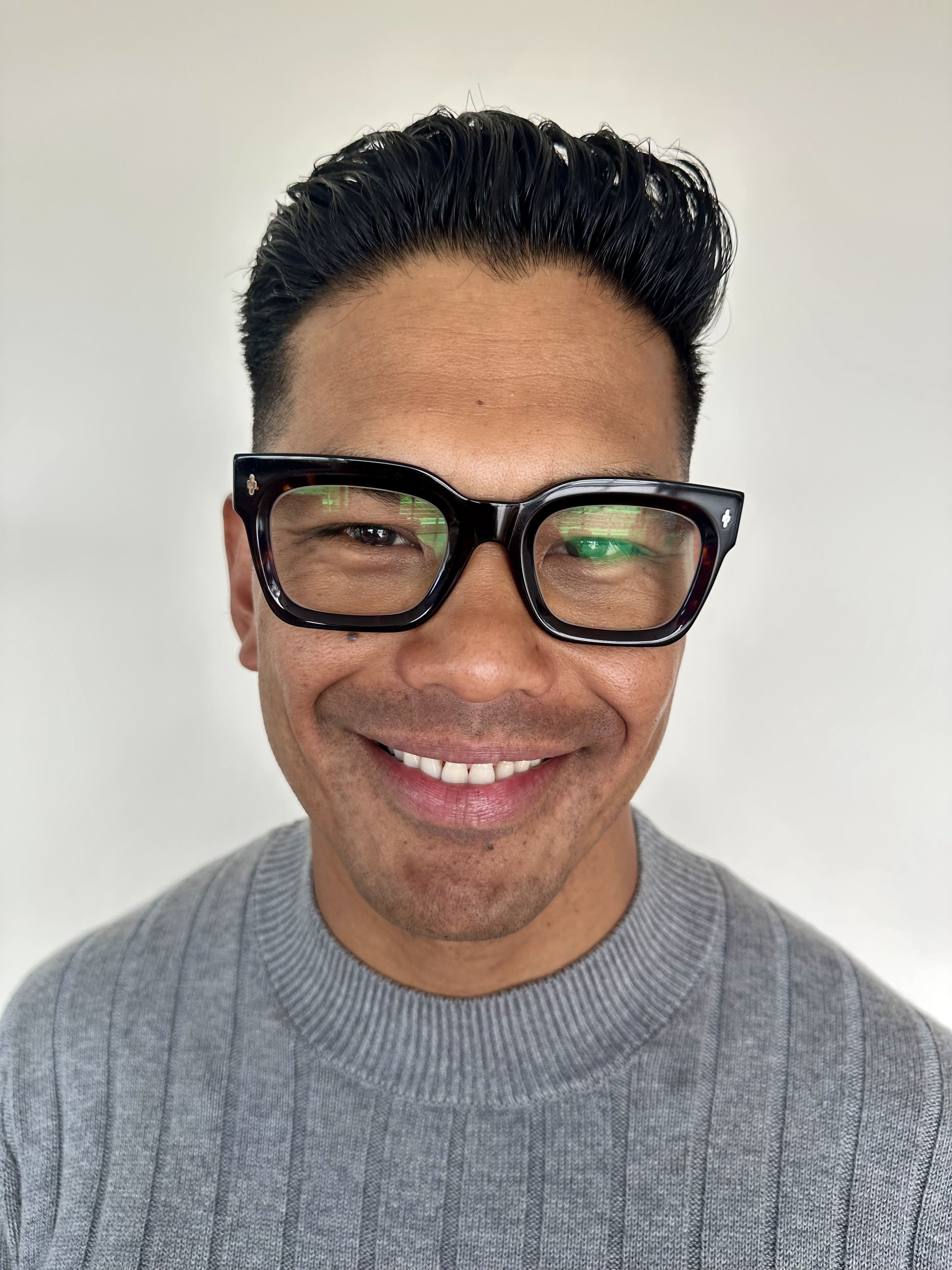 Man wearing premium square black reading glasses with blue light blocking and a gray sweater 