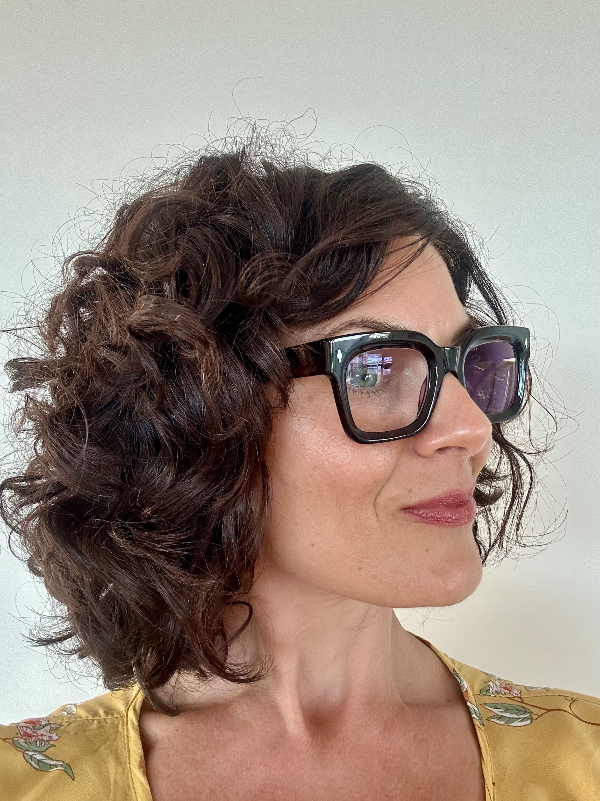Woman with styled hair wearing blue-light blocking reading glasses ministry of sight readers