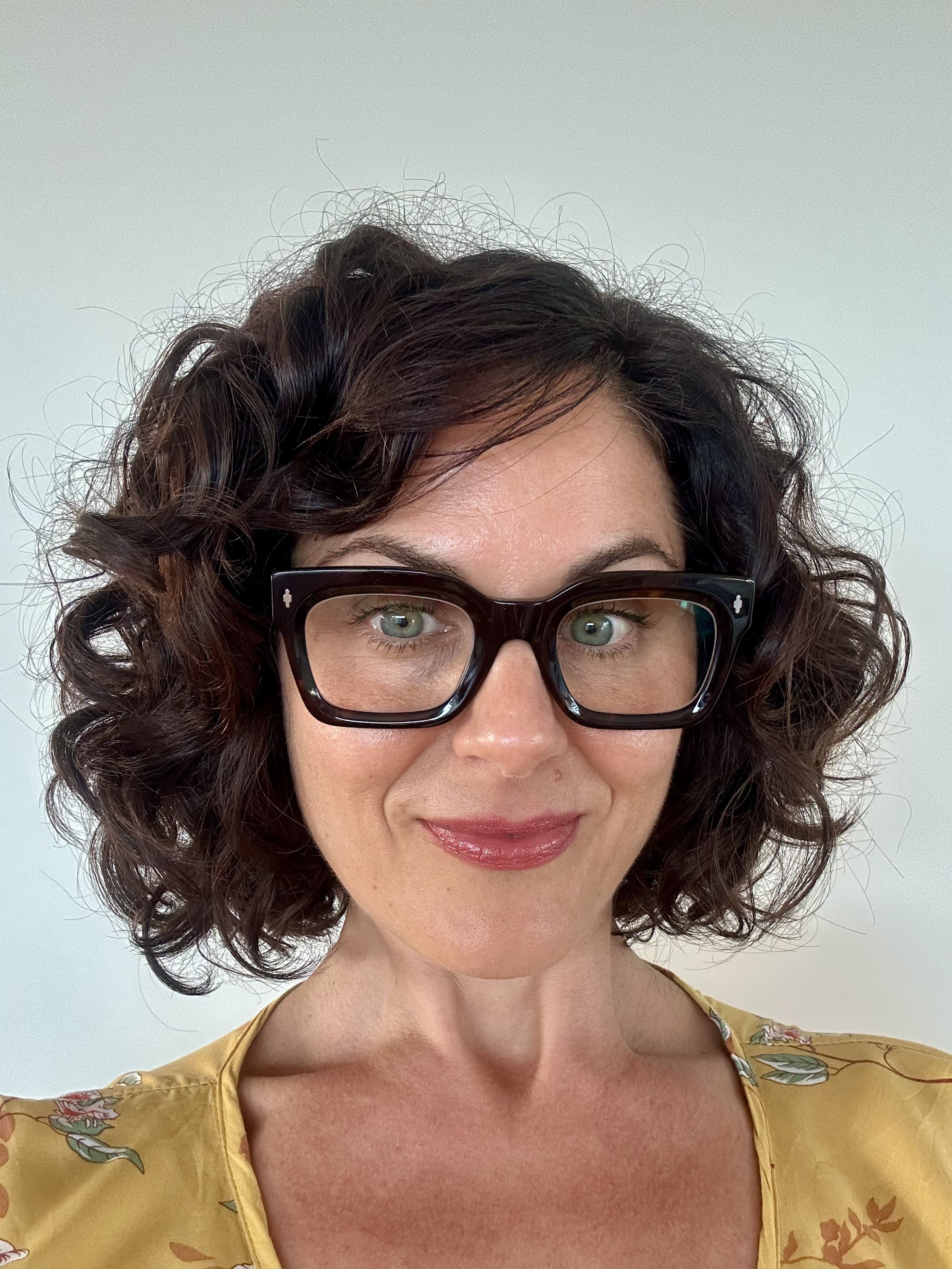 Australian woman wearing black stylish blue-light blocking readers 
