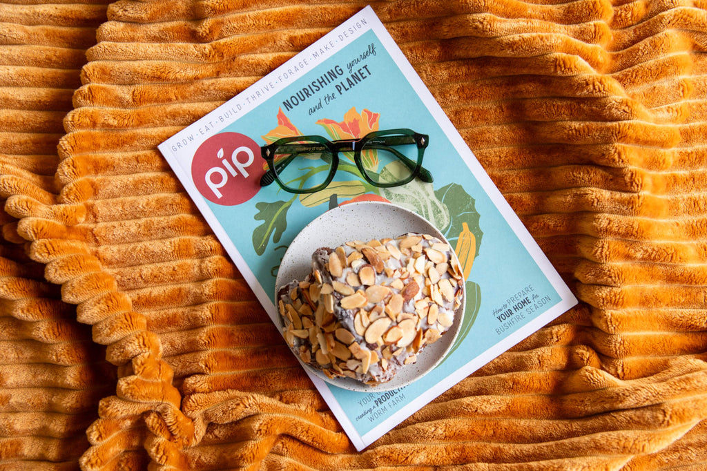 Pip packaging with a bowl of granola on a textured orange surface with green stylish reading glasses at breakfast - ministry of sight readers