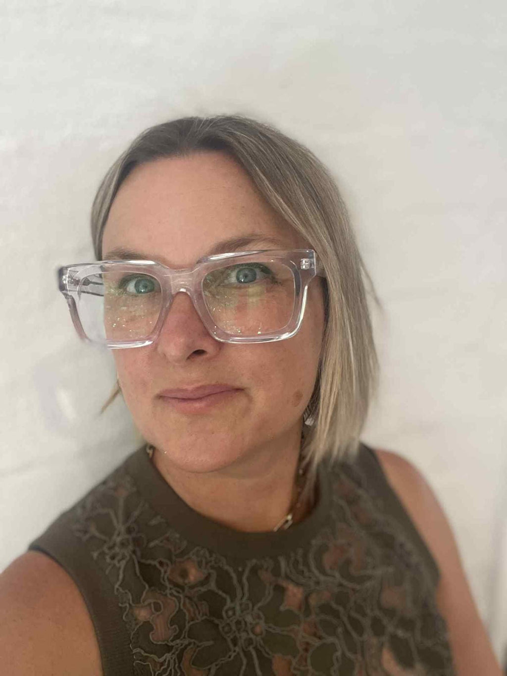 Australian woman wearing stylish clear glasses against a plain background - Ministry of Sight