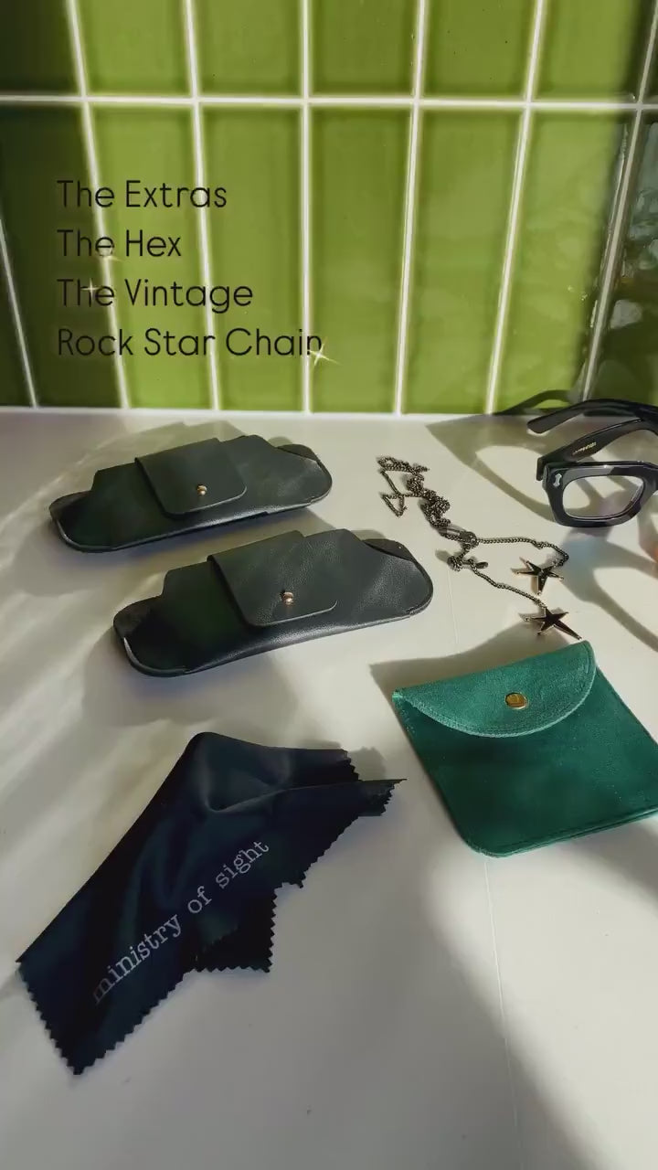 Ministry of Sight reading glasses and rock star chain flat lay in kitchen