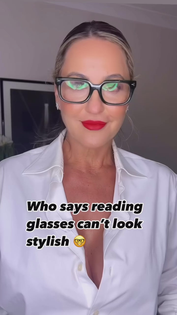 Australian woman wearing stylish reading glasses in a white button down shirt and red lipstick