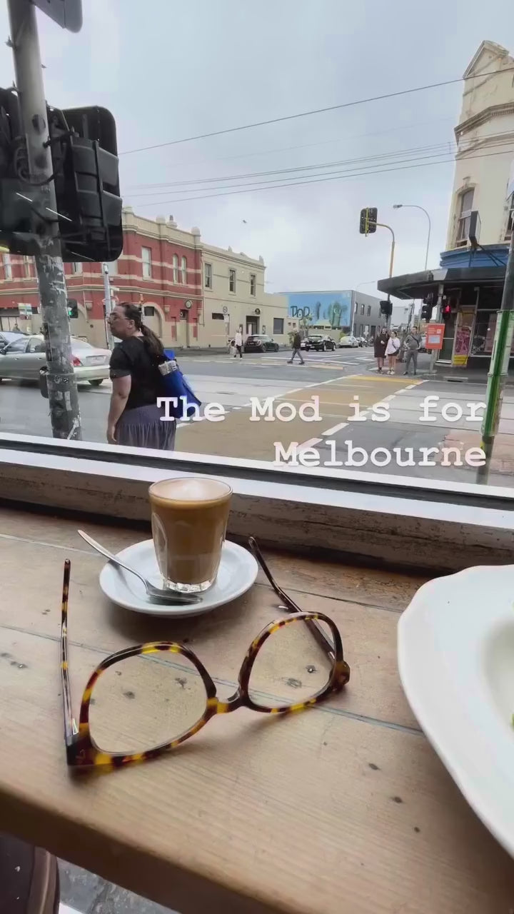 Premium blue-light blocking reading glasses in cafe in Melbourne with coffee